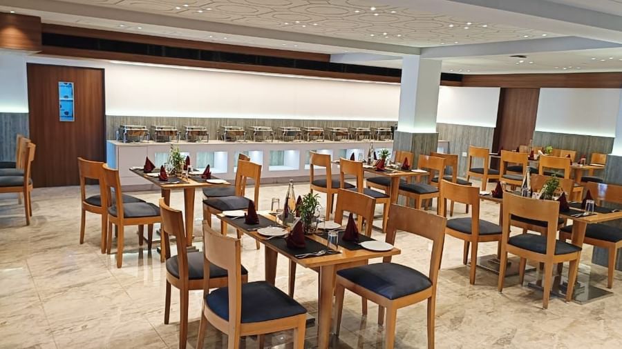 All-day dining restaurant at Lords Eco Inn Dahej offering a welcoming ambience with wooden décor.