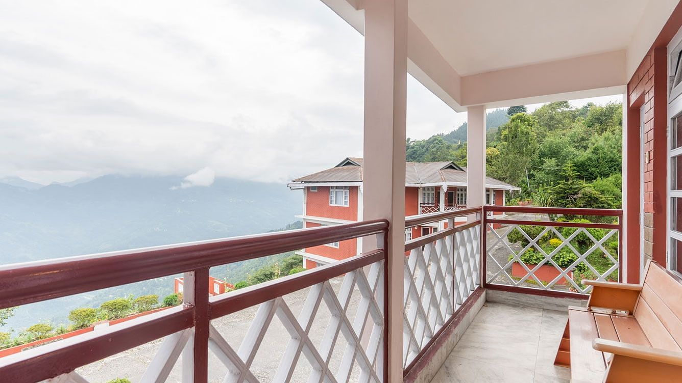 Image of a balcony with bench and view of the mountians at at Summit Tashi Ghang Heritage Resort, Pelling