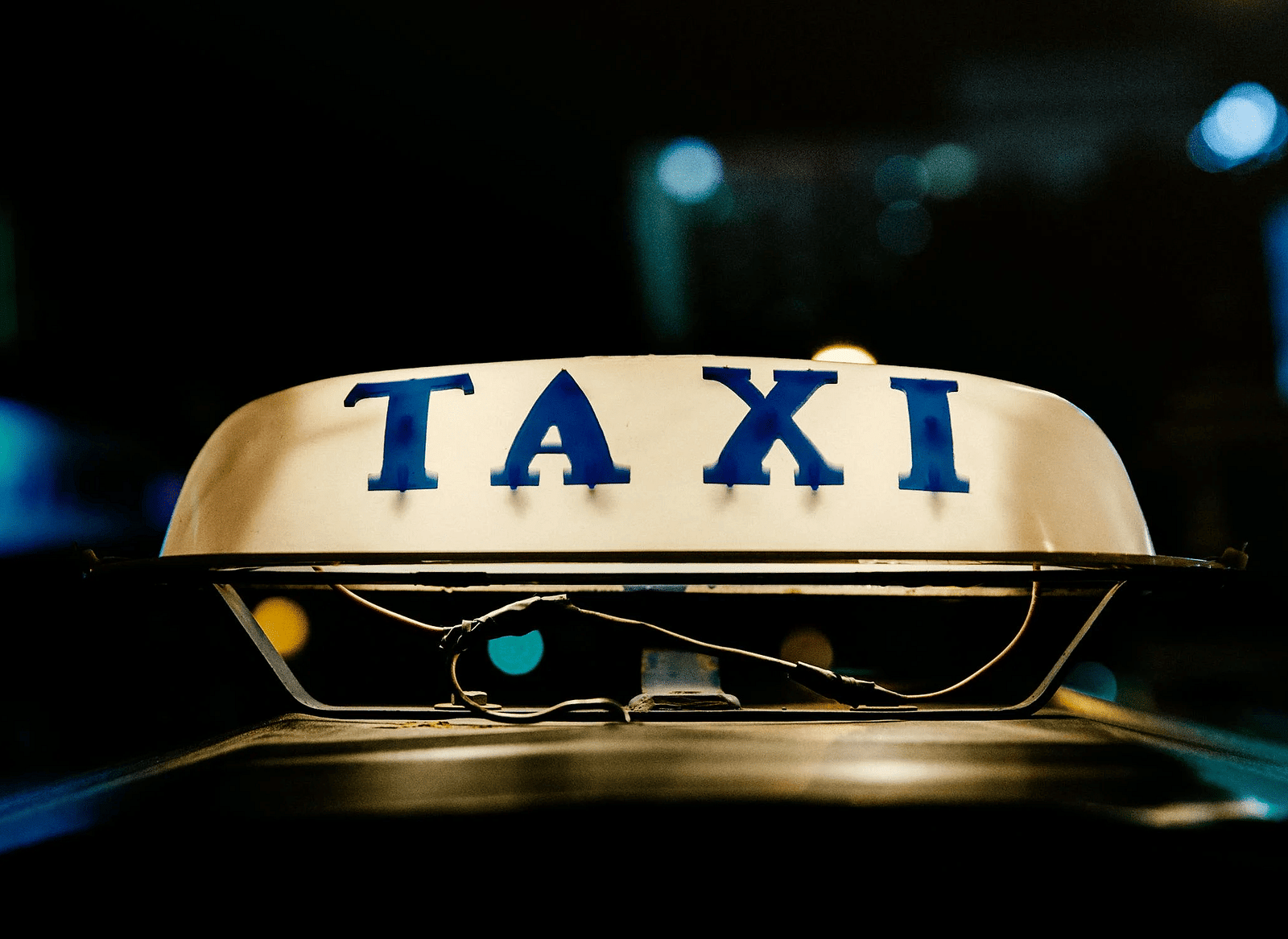An illuminated sign featuring the word 'taxi' displayed prominently.
