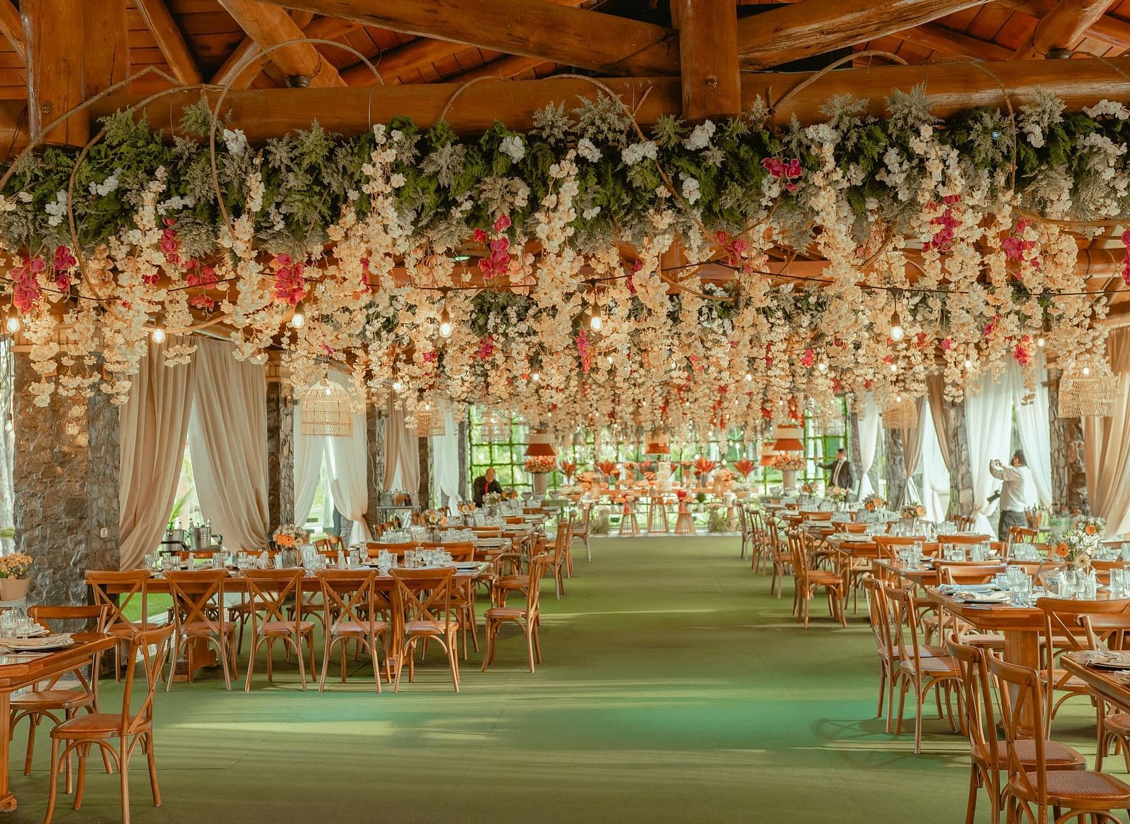 Elegant dining space with a floral canopy, creating a romantic atmosphere for guests.
