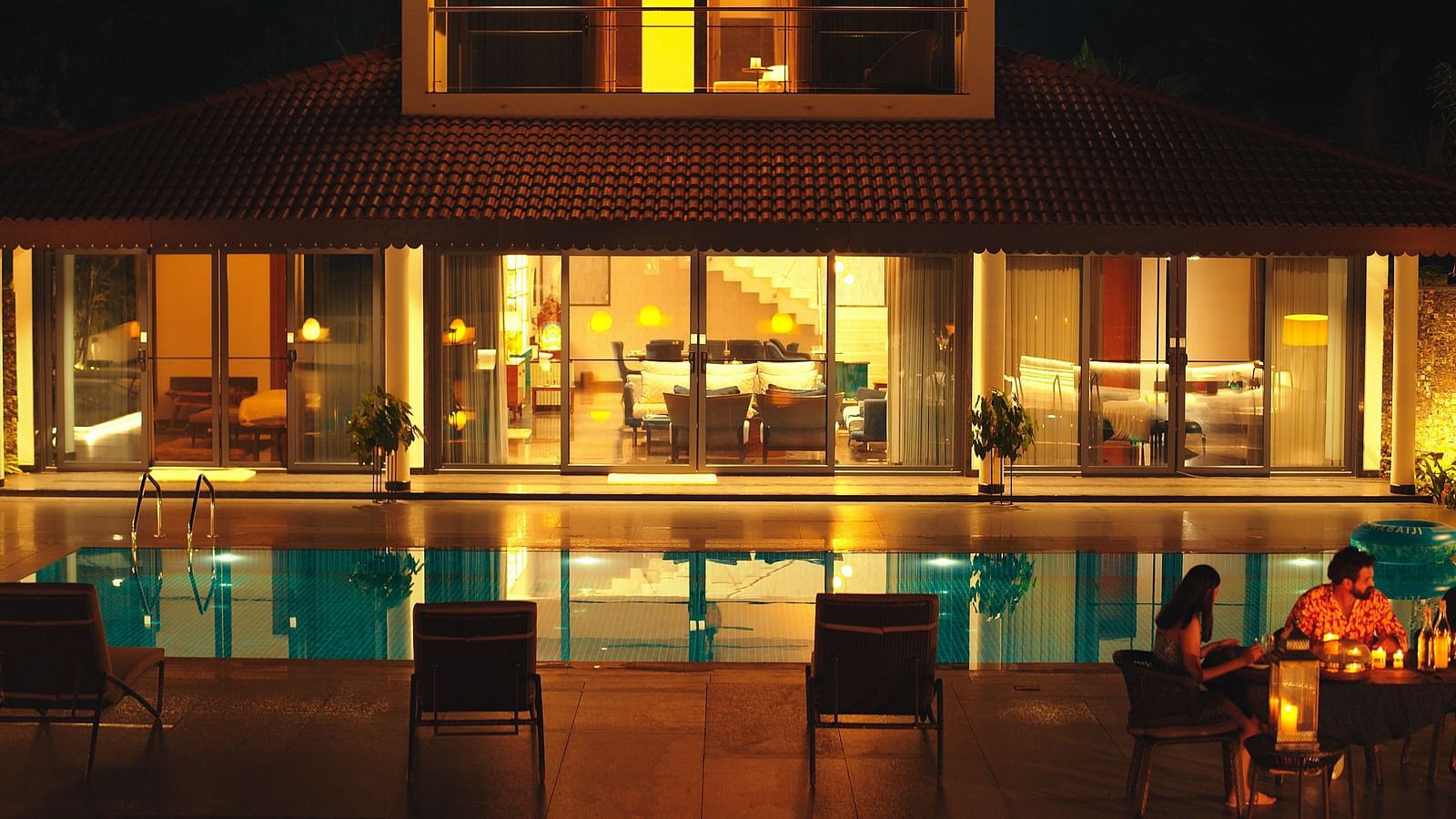 overview of the swimming pool at night in the luxurious villa - Gamyam Retreat