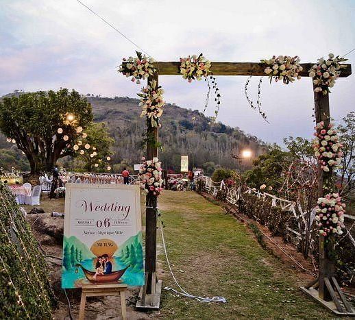a decorated entrance for a wedding leading to the open space hall - neer ganga Resorts