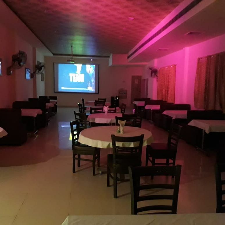 An image of a bar near IIT Roorkee decorated with cosy lights and tables - Motel Divine International, Roorkee