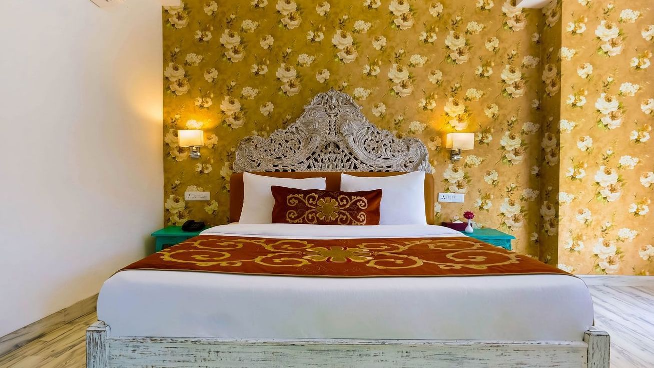 Image of a room with wooden bed and lamps on the side of the bed at Summit By The Ganges Beach Resort & Spa, Rishikesh
