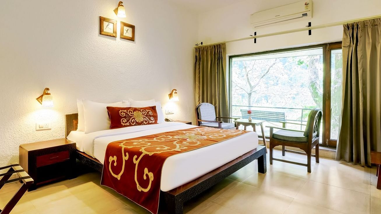 Image of a room with bed and large windows at Summit By The Ganges Beach Resort & Spa, Rishikesh