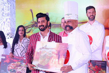 Chef receiving a painting at a GRT event