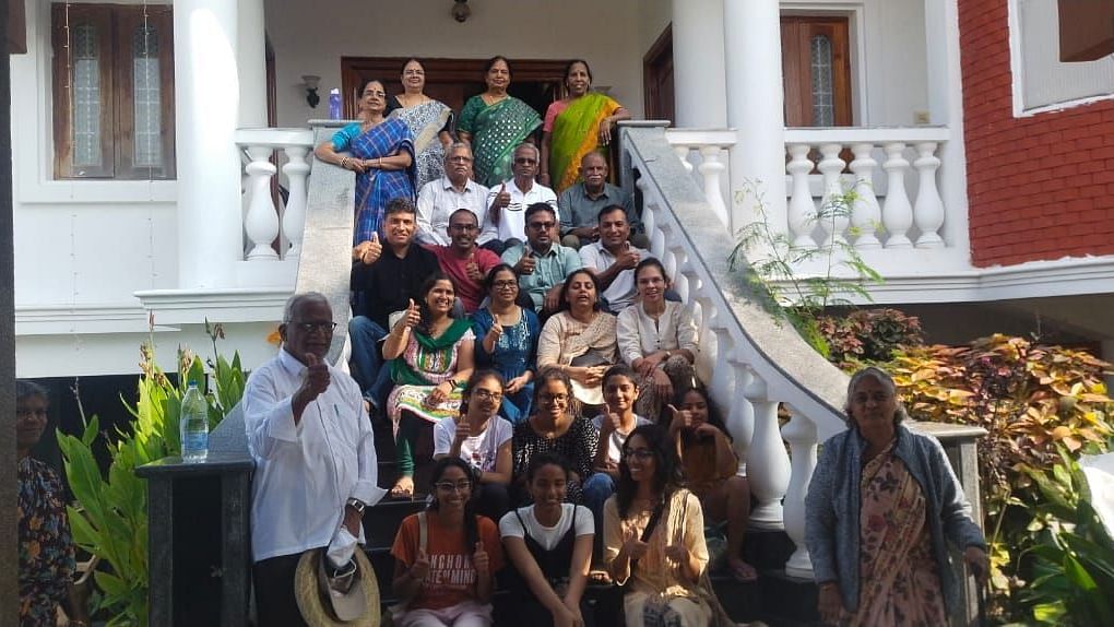 Image of a group of people sitting on the stairs and posing for a photo at Villa Serenity Le Sejour Pondicherry.