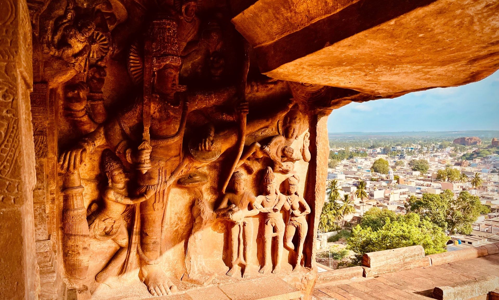 Badami Cave Temple carvings with town view.