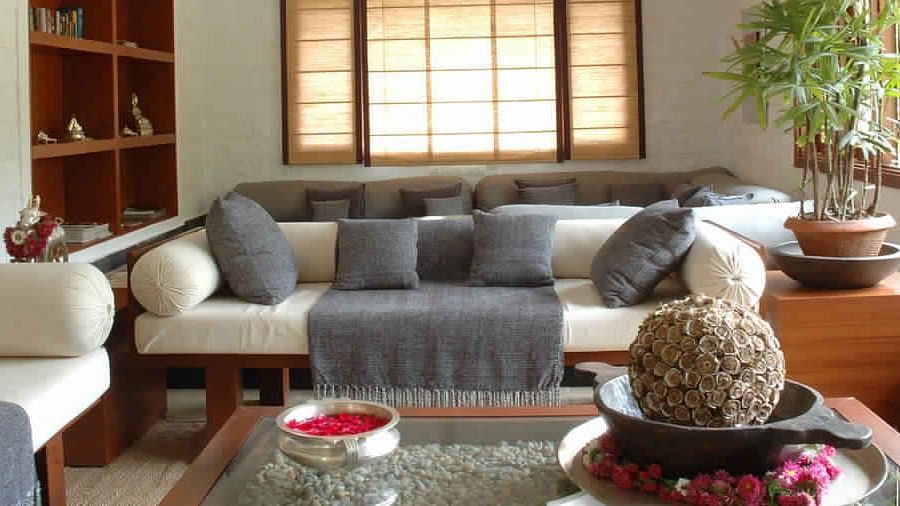 A living room with a gray couch, a wooden table - Shreyas Retreat