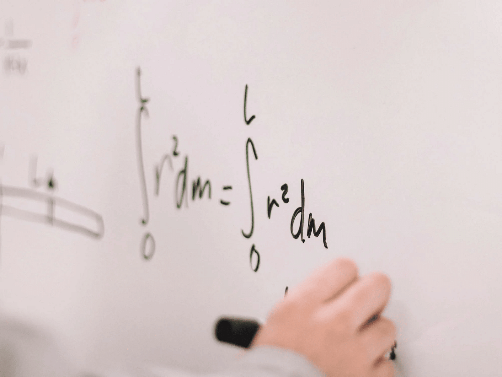 A whiteboard with mathematical equations written on it.