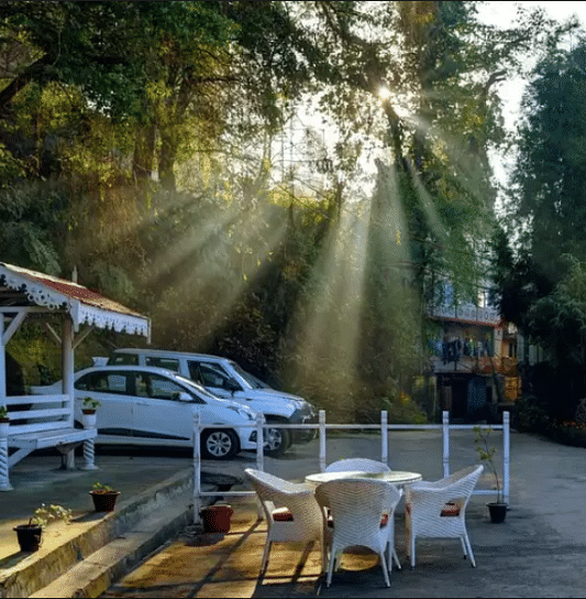 Chairs placed for seating with a parked car behind. 