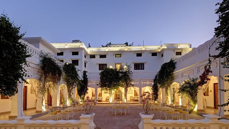 A wide view of the central courtyard at Saraca Hotel, Lucknow during blue hour