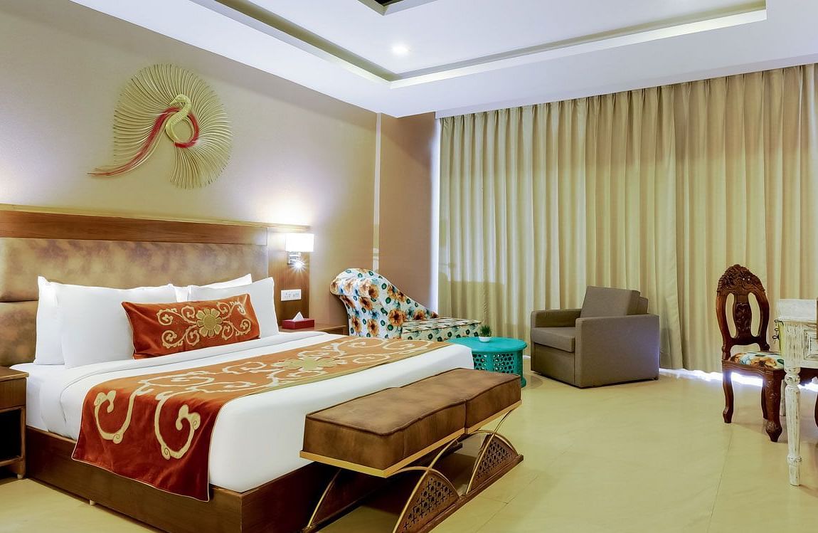 Image of a room with bed and a fancy decor piece above it at Summit By The Ganges Beach Resort & Spa, Rishikesh