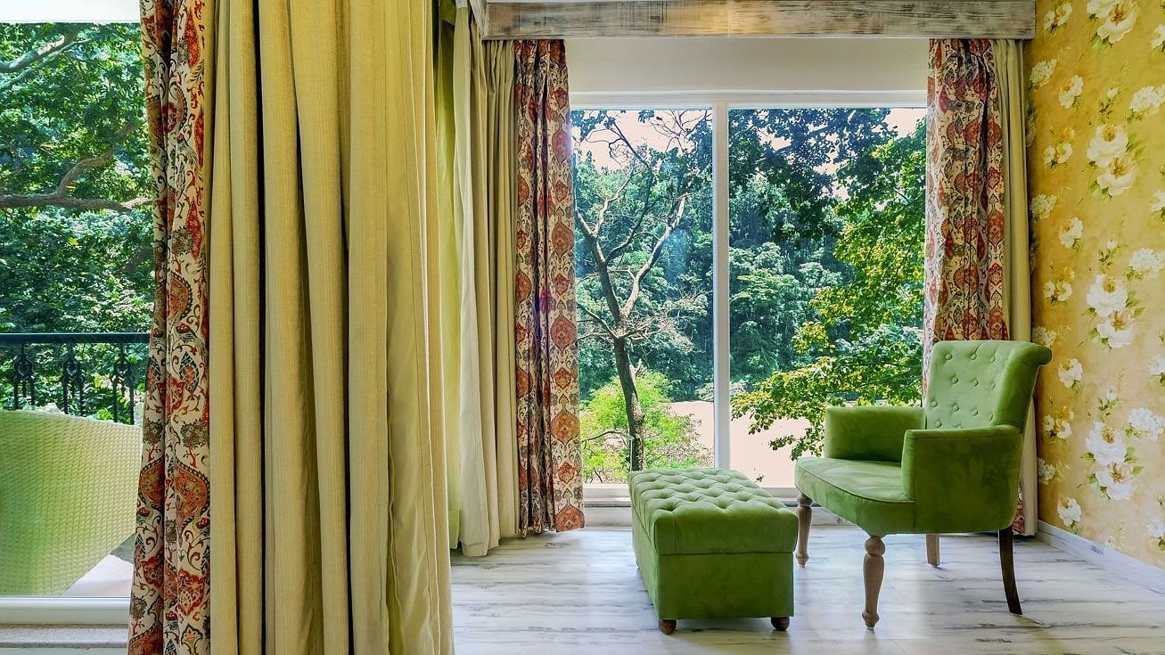Image of  asitting area with large windows at Summit By The Ganges Beach Resort & Spa, Rishikesh