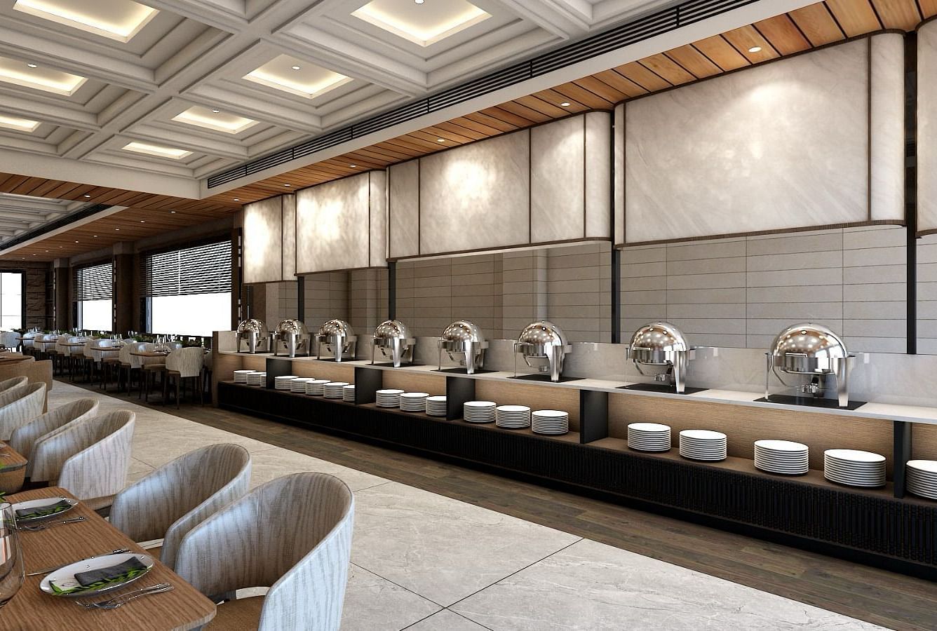 The buffet counter with various porcelain plates lined up together right behind the dining area of the restaurant - Namaste Corbett