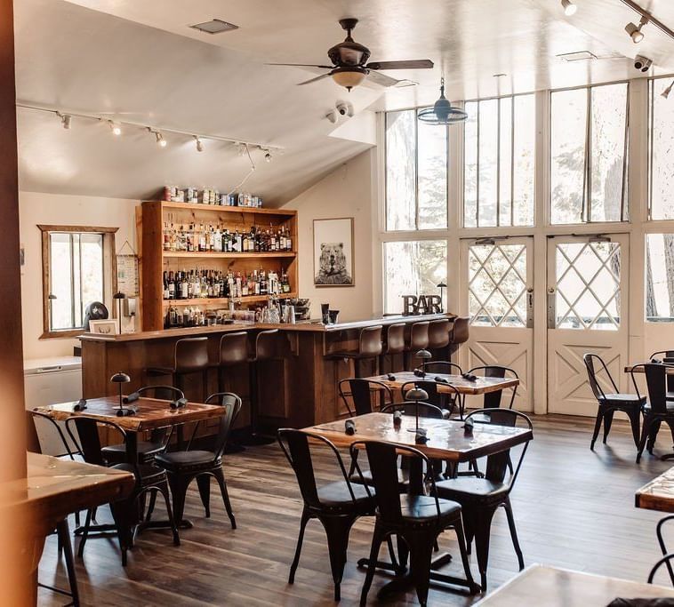 Interiors of a restaurant with seating arrangement and a bar counter