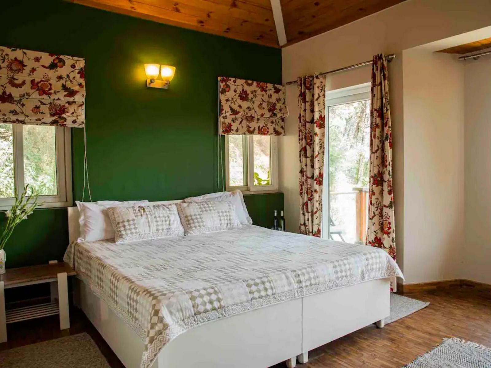 A large bed in a bedroom next to a nightstand and nightlamp above in 3 BHK at  at SOUTHGATE KASAULI BY ZENQ.