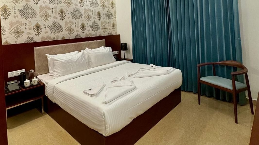 Image of a room with bed, chair and a fan on the ceiling at Le Royale Palace.