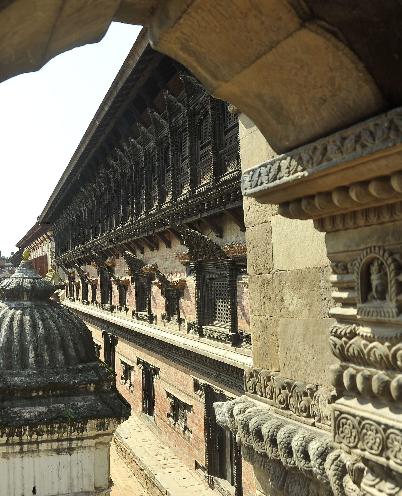 The Palace of 55 Windows in Durbar Square offers a stunning view from beside the pillar arch, looking outwards.