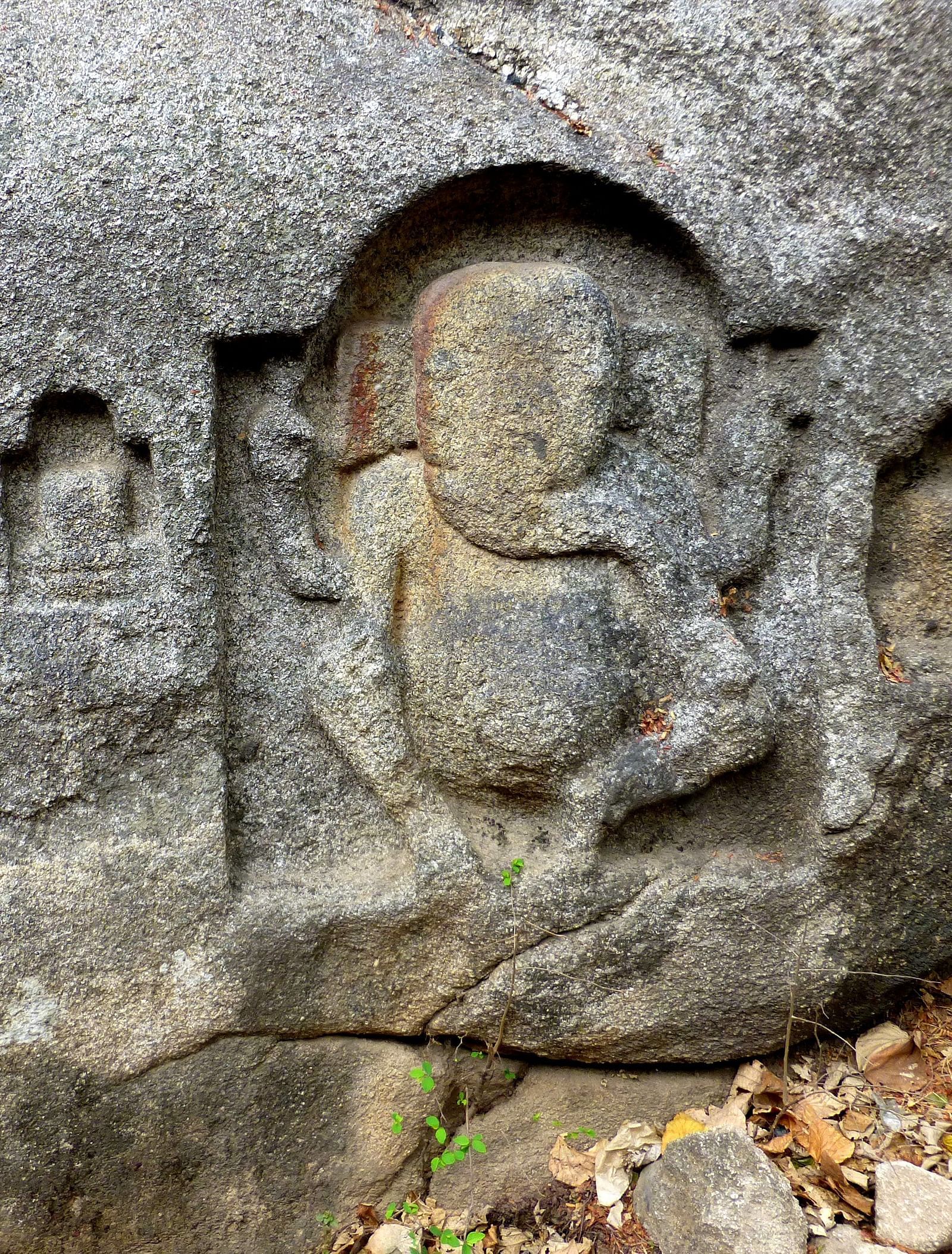 image of stone carvings on a cave wall with lord ganesha imprinted on it