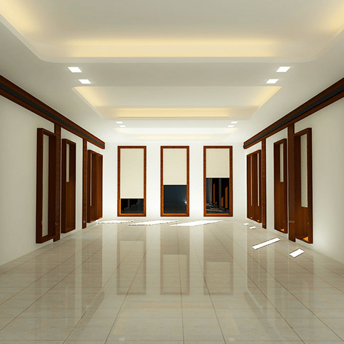 A brightly lit Waves Hall at Uday Samudra Leisure Beach Hotel, Kovalam, features numerous wooden frames lining the white walls and tiled floor.