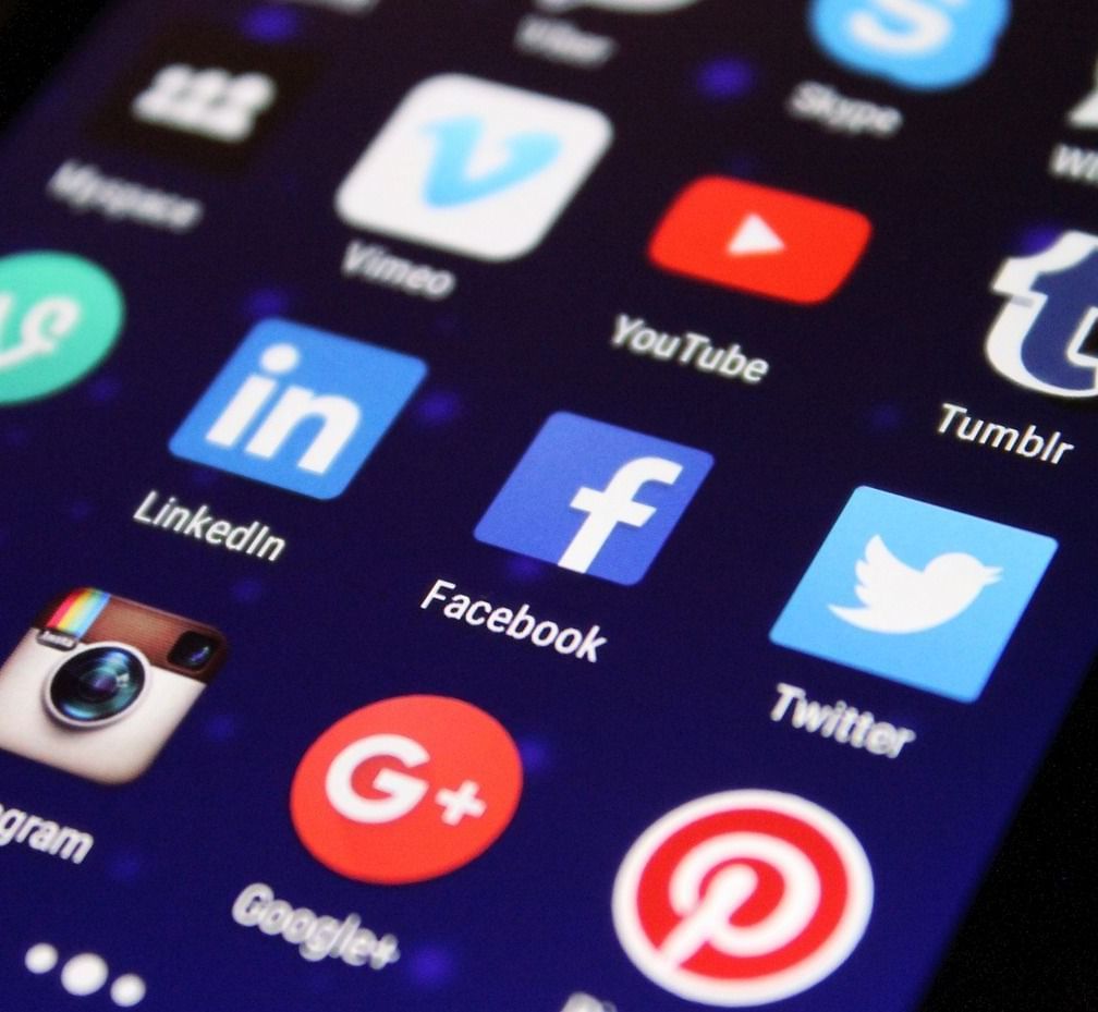 Close-up shot of a mobile screen interface showcasing various social media applications with three carousel dots in the bottom of the screen.