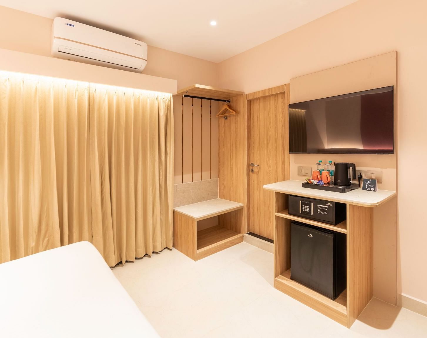  Kitchenette with a fridge and wardrobe in The Executive Rooms at TGI Livancia The Sojourn, Bangalore.