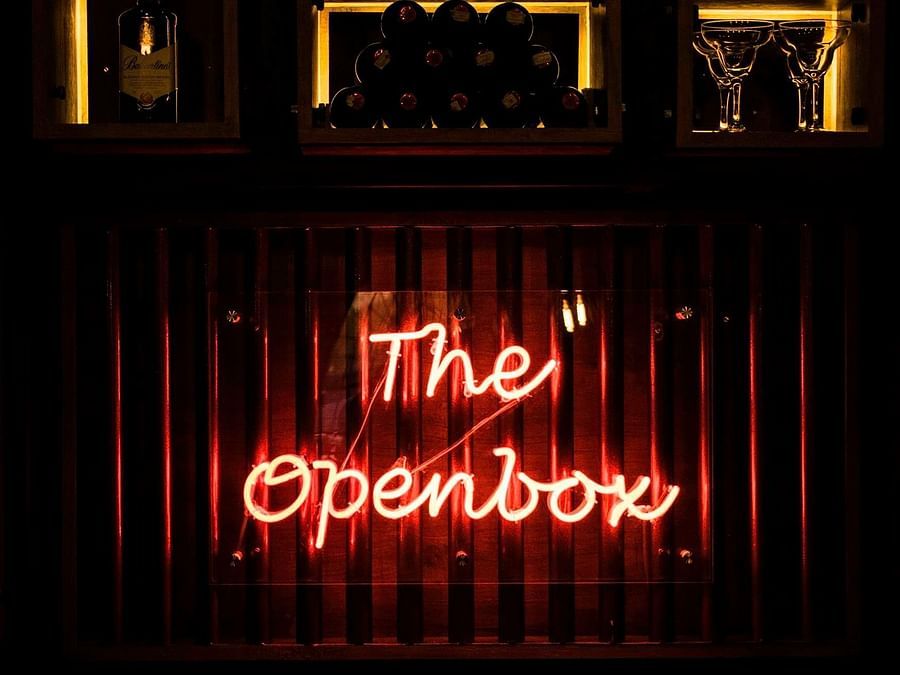 The Open Box logo is illuminated on the wall. - Wedlock Greens Hotel Resorts Dhanbad