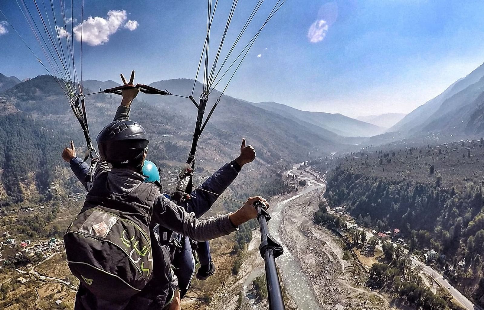 An image of two individuals paragliding 
