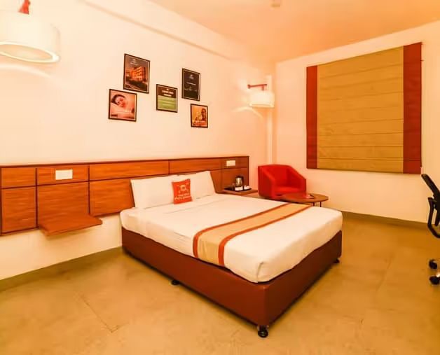 A stylish and cosy hotel room with a king size bed, soft lighting, and contemporary decor - Max Hotel Prayagraj.