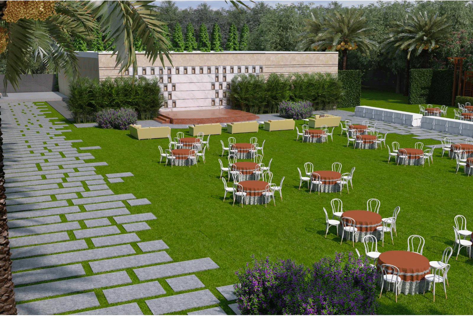 A wide view of lawn with stage, tables, and chairs on grass, stone pathways on either side, and palm trees around the area at Merlis Hotel, Coimbatore