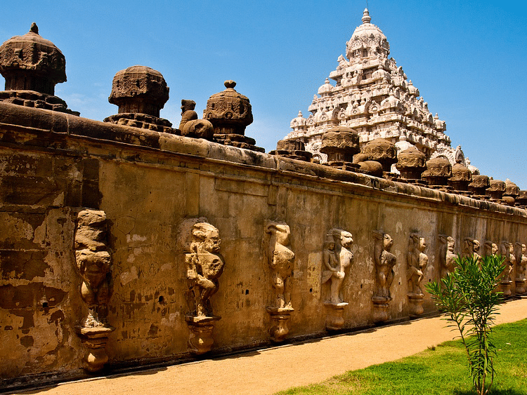 Historic stone temple with intricate carvings and a pyramid-shaped tower.