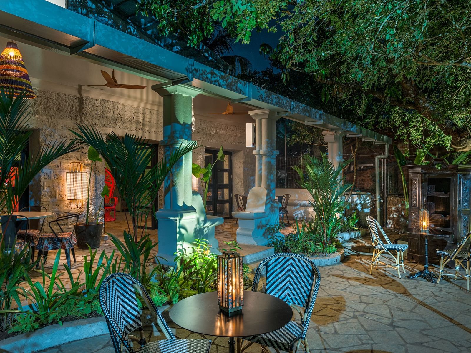 Outdoor seating arrangement with a lantern on the coffee table at Village 36