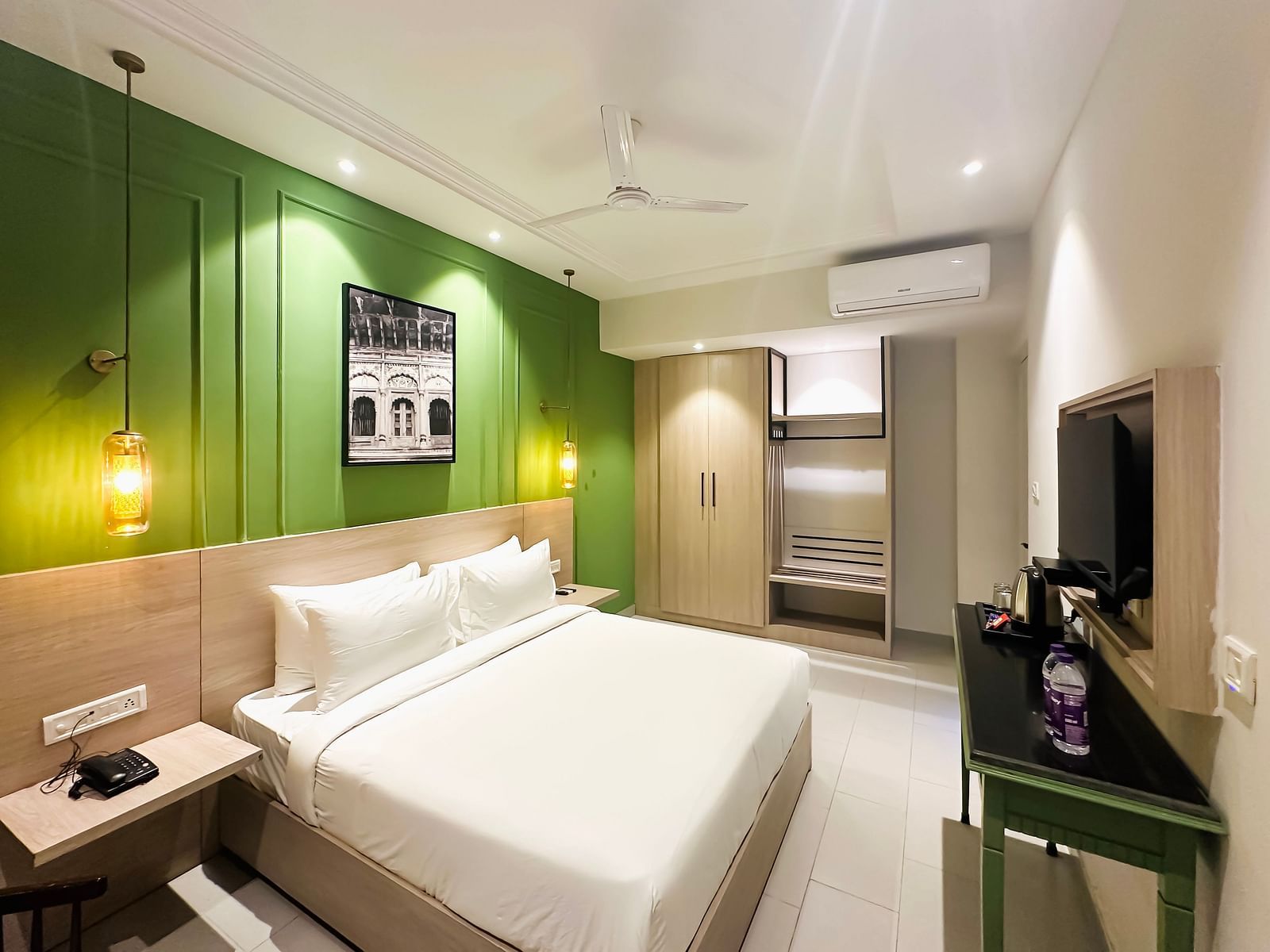 A hotel room with a large bed in front of a television - Wonder Hills