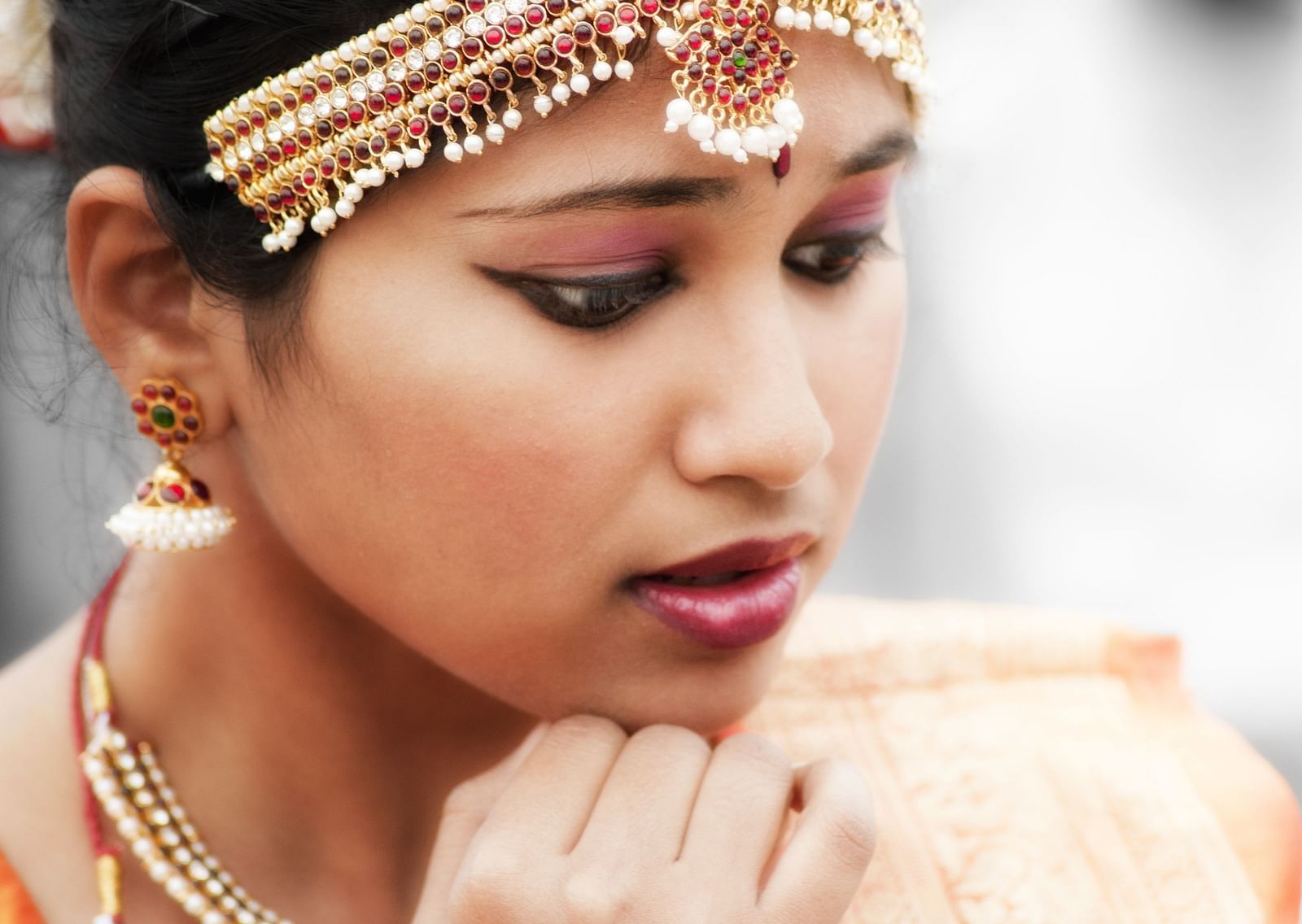 A close up shot of a bharatanatyam dancer with the traditional attire on.
