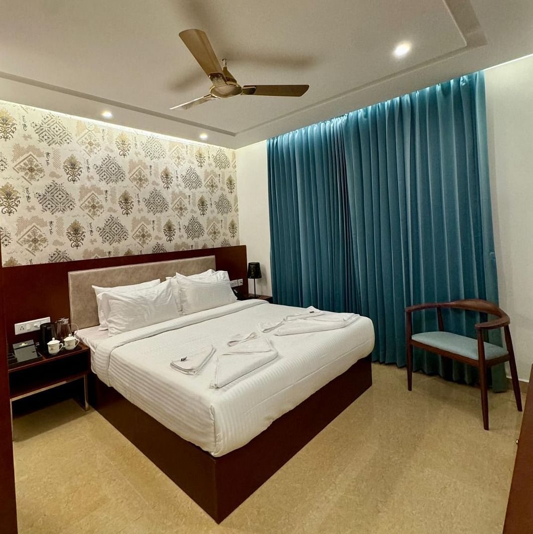 Image of a room with bed, chair and a fan on the ceiling at Le Royale Palace.
