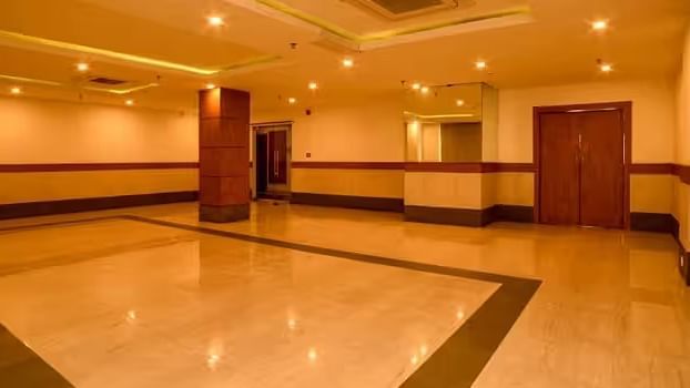 View of banquet hall called The Durbar with polished flooring and ample space for events - Max Hotel Prayagraj.