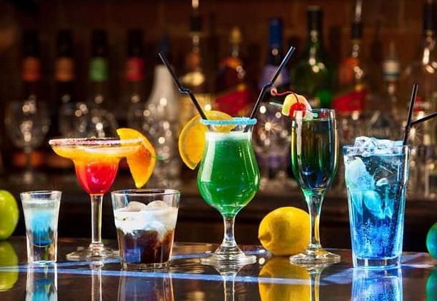 Image of a variety of drinks placed on a table at Coorg Jungle Camp Backwater Resort, Kushalnagar.