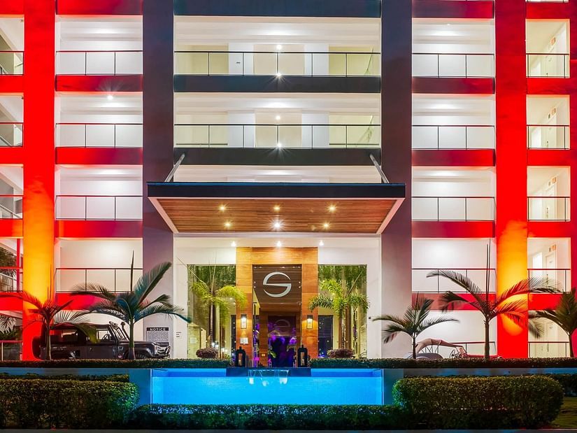 An entrance to a hotel illuminated by orange and warm lights - S Hotel Montego Bay, Jamaica