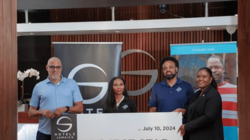 Representatives from the S Hotel Foundation presenting a donation to community members during an official event, showcasing the organisation’s dedication to local empowerment and social welfare.