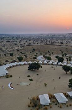Twilight descends on the tented camp, captured from above, showing the landscape's vastness and the camp's seclusion - MANVAR Resort & Desert Camp