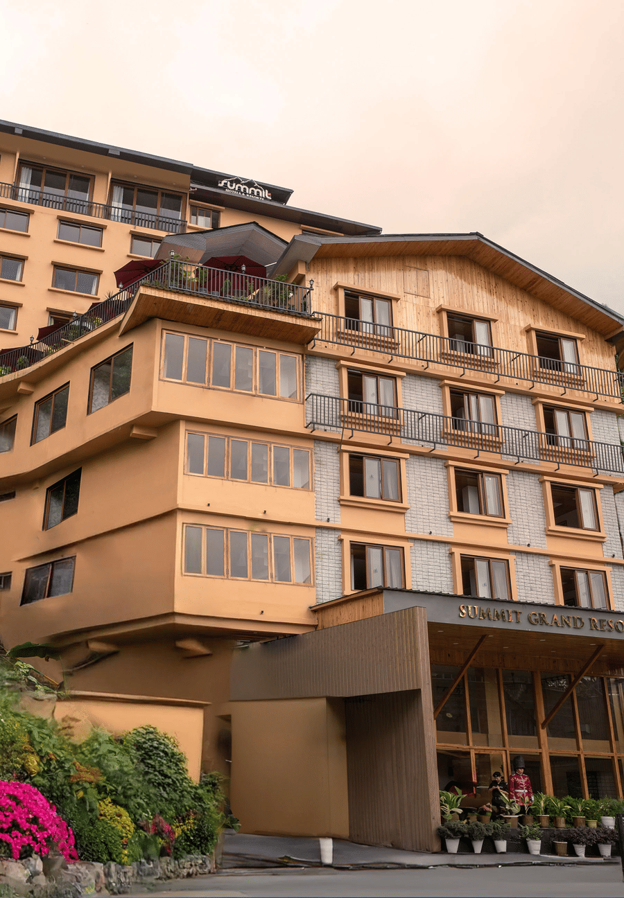 Facade image of Summit Grand Resort & Spa, Gangtok, with trees lining the pathway
