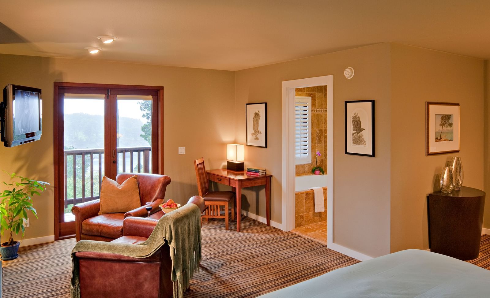 A cosy room in Mendocino with warm lighting, plush seating, and scenic views - Brewery Gulch Inn & Spa