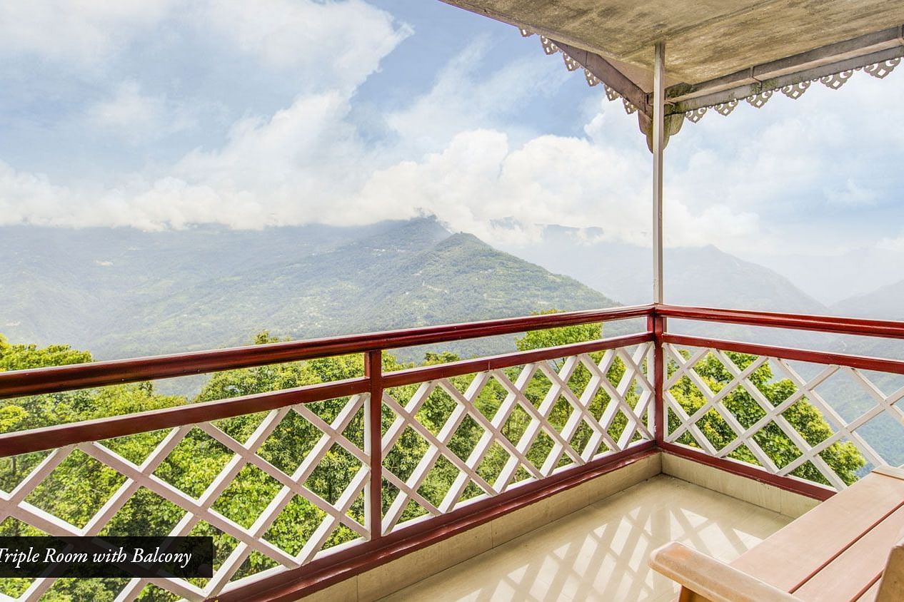 Image of a balcony with sitting area and view of the mountians at Summit Tashi Ghang Heritage Resort, Pelling