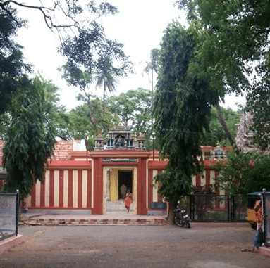 Facade of Peri Avudaiyar Temple situated amidst lush green foliage