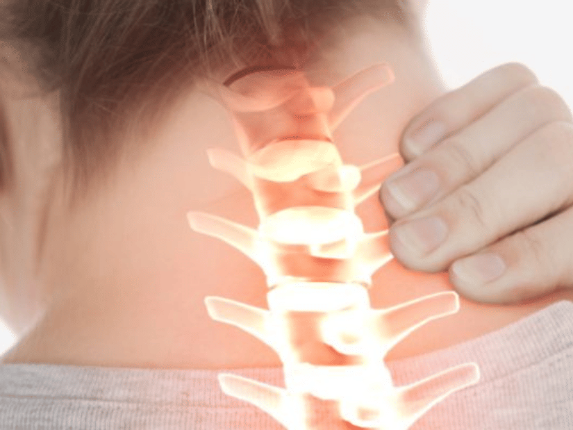 A person holding the back of their neck, with the spine highlighted in glowing orange