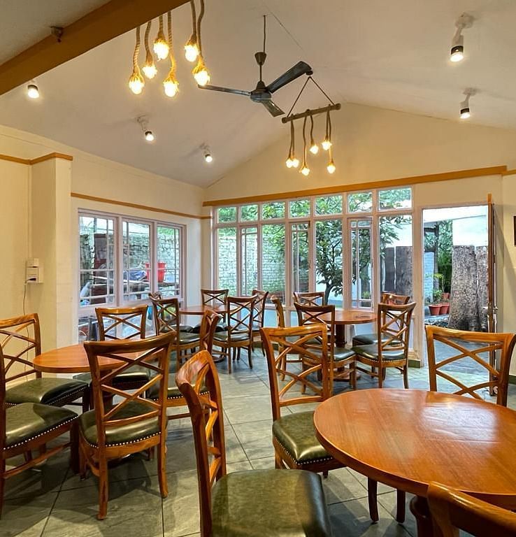  Wooden chairs and tables are neatly arranged in the dining area
