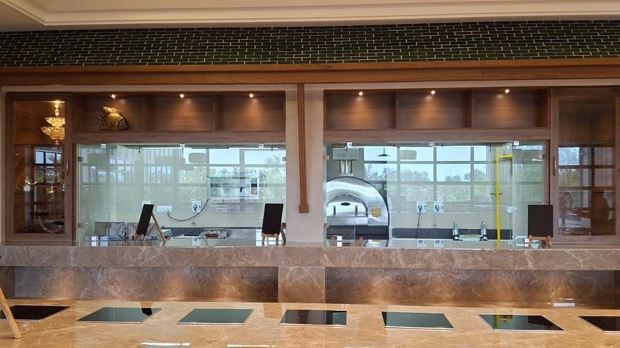 View of the kitchen in one of the dining outlets at Cloud9 Sarovar Premiere, Goa, showcasing the clean, organised space where meals are expertly prepared