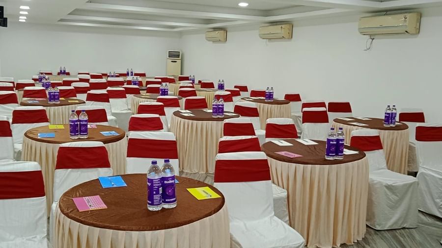 Round tables and chairs covered with cloth, and warm overhead lighting enhance and reside in the Emerald banquet hall of Mountview Resort.