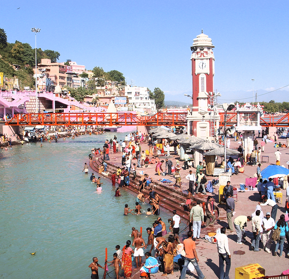 a crowd of people taking dips in a river turn by turn